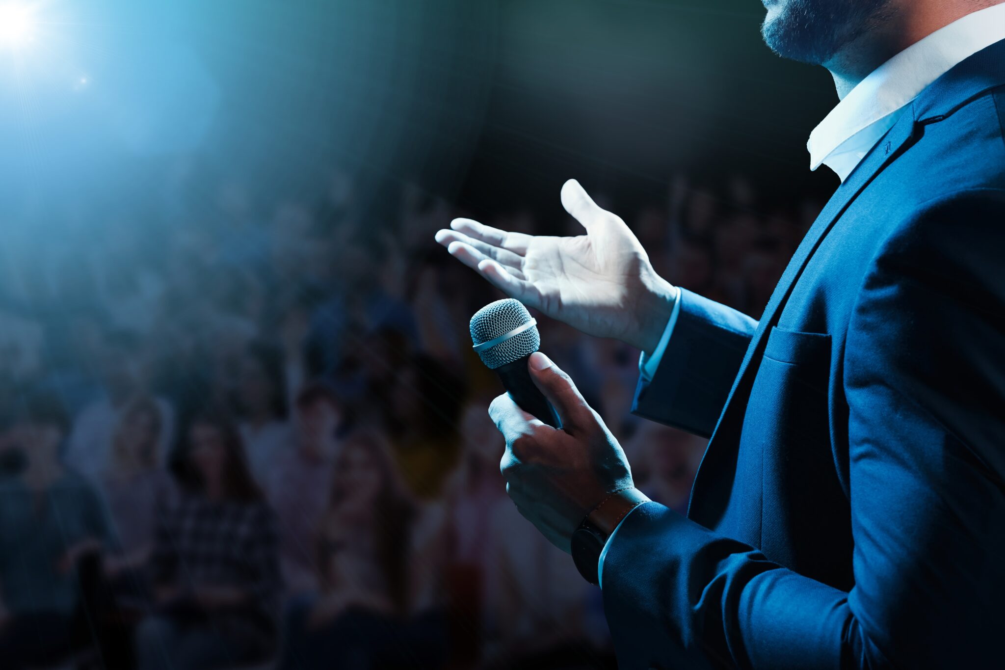 Motivational,Speaker,With,Microphone,Performing,On,Stage,,Closeup